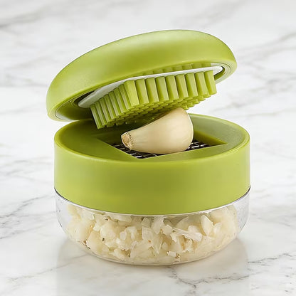 Garlic Mincer Jar in use pressing fresh garlic cloves into mince